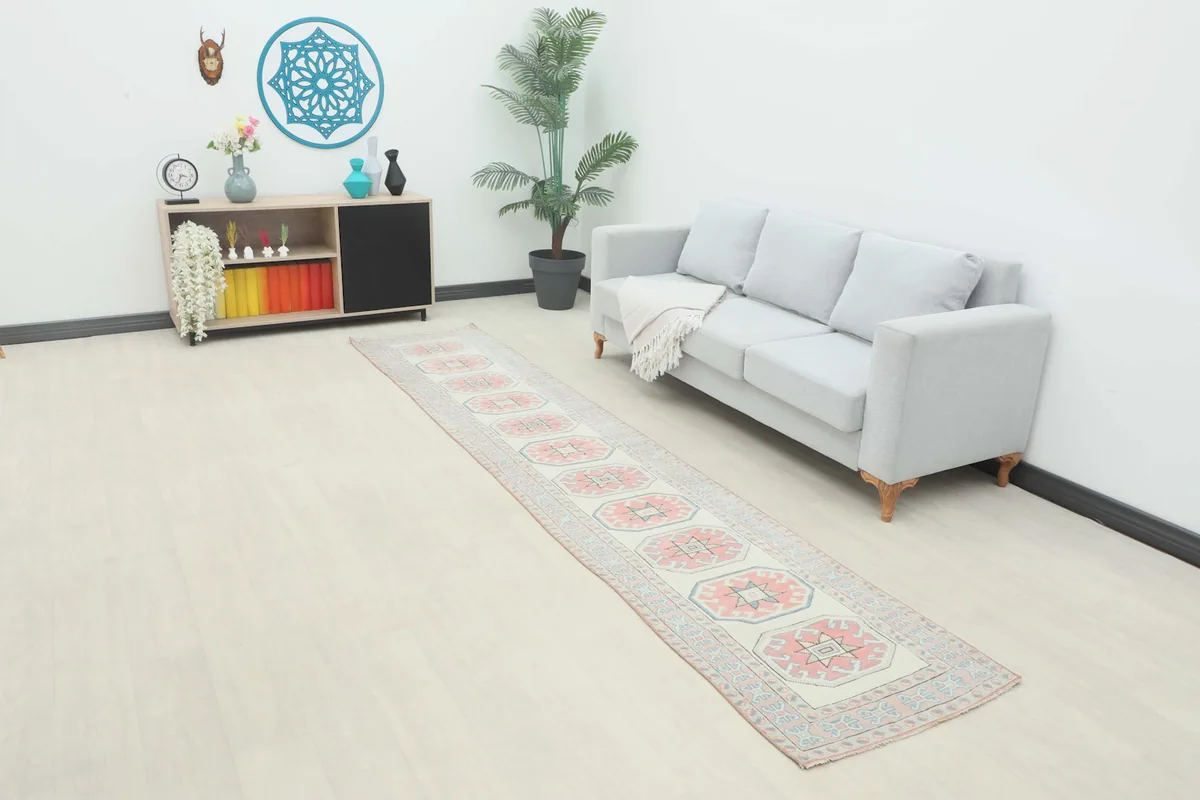 Rose Ivory Geometric runner displayed in a contemporary room setting with a light-colored sofa.