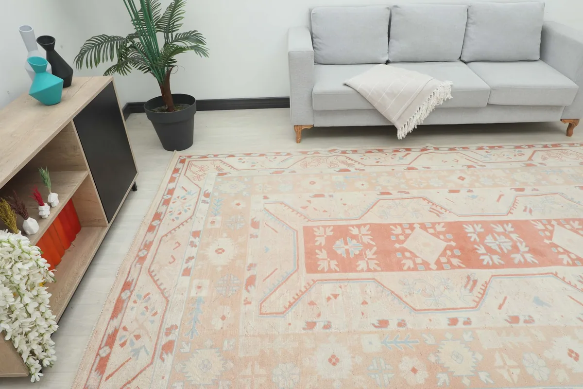 Angle view of the large vintage rug in a living room, showing its scale next to furniture
