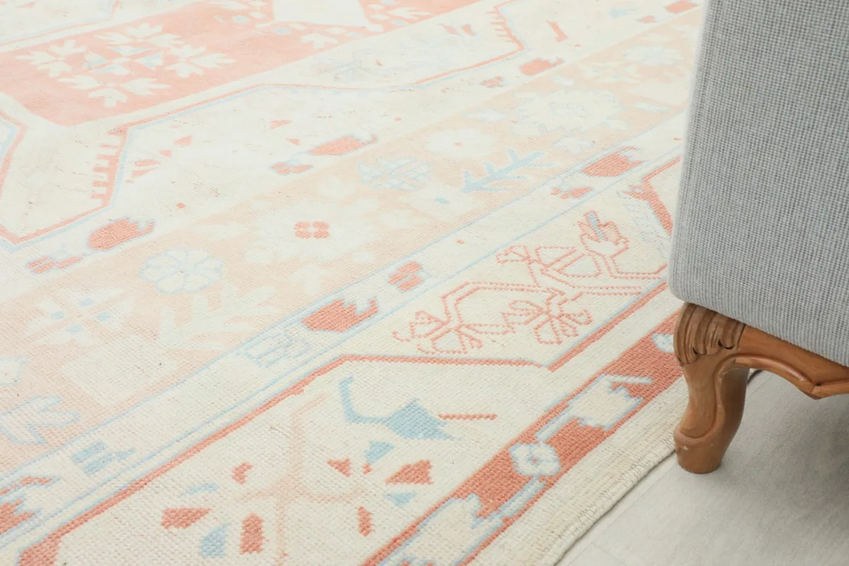 Close-up of the rug's low pile and intricate geometric design next to a furniture leg