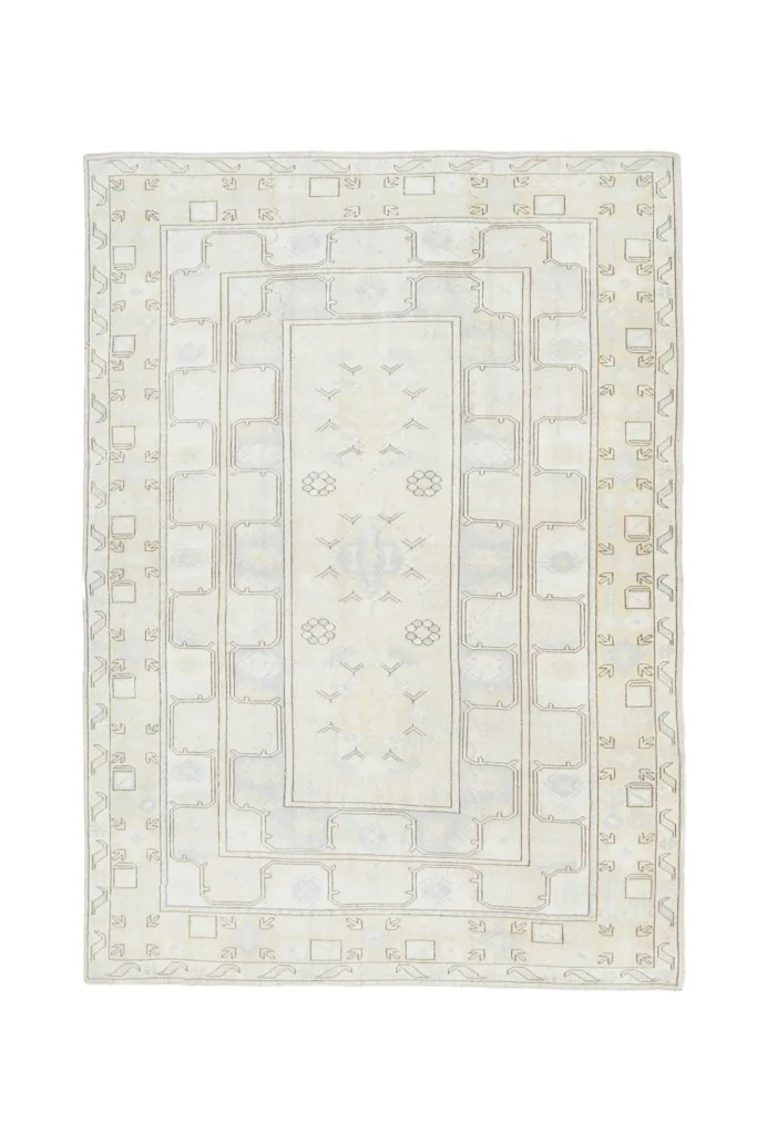 Overhead view of the entire ivory and beige vintage Anatolian rug, showcasing its full design.