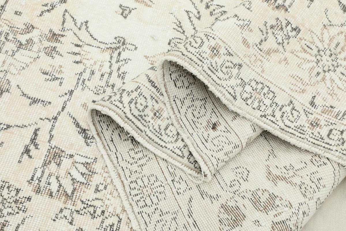 Another rolled view of the rug, emphasizing the texture and pattern details