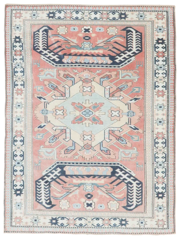 Full top view of the 5'9" x 7'8" vintage Anatolian area rug on a white background, displaying its rose field and navy