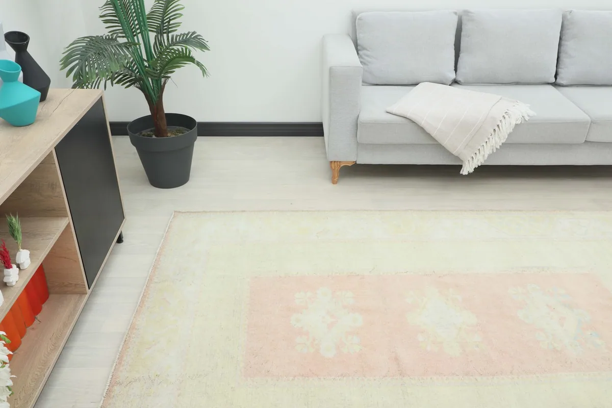 Angle view of the rug in a living room, highlighting its placement next to a modern cabinet