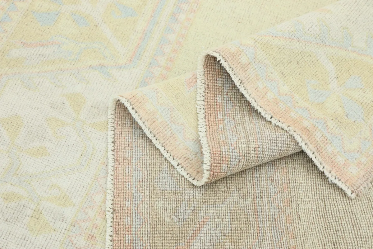Rug folded to display the reverse side, showing the hand-knotted construction