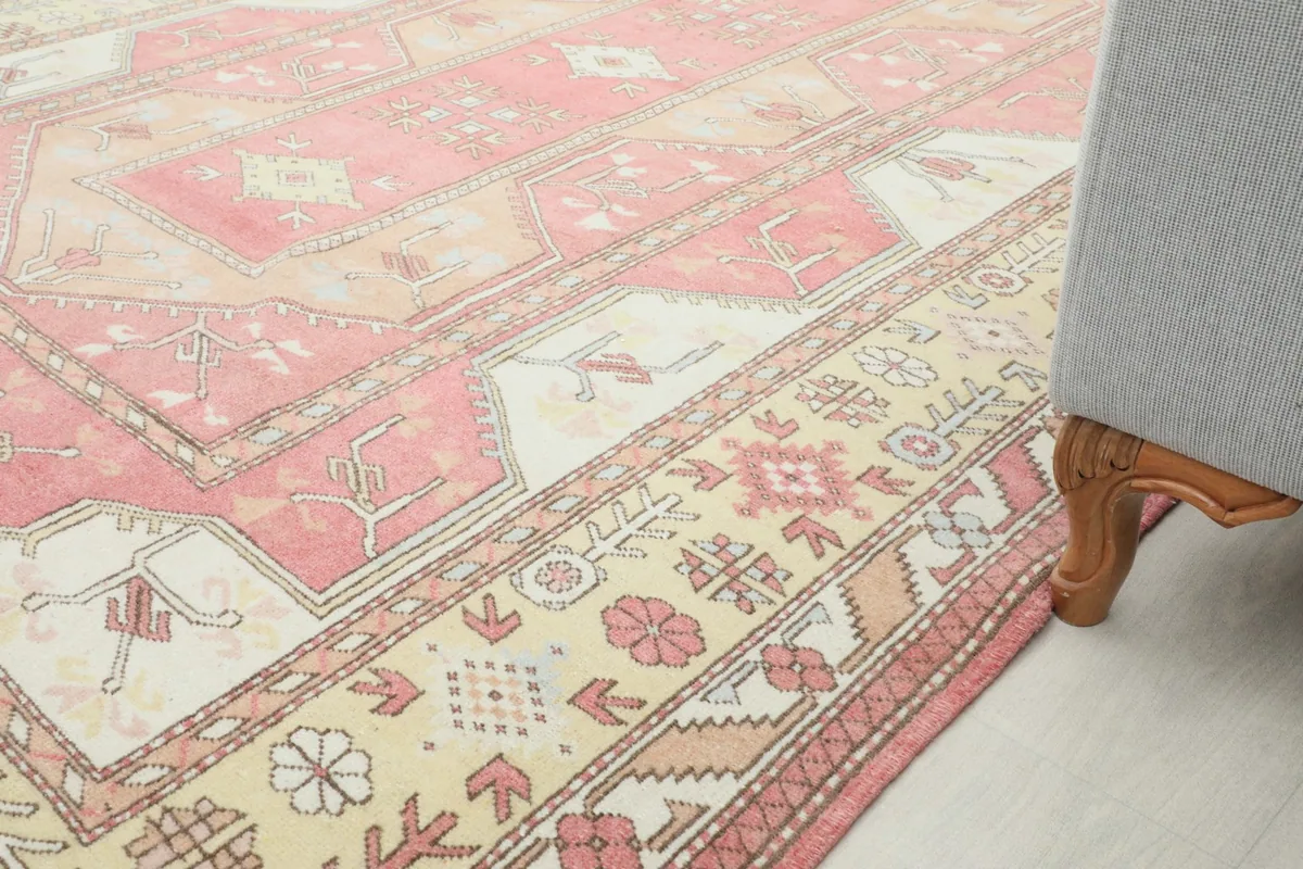 Side view of the rug next to a couch, emphasizing its size and color in a home environment.