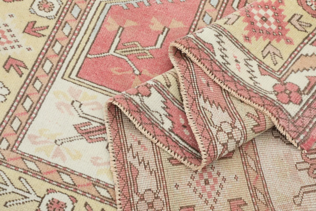 Partial fold of the rug, showing the flexibility and texture of the hand-knotted wool.