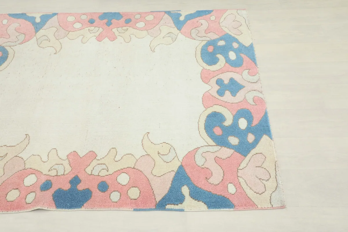 Another corner view of the rug, focusing on the intricate border patterns and colors.