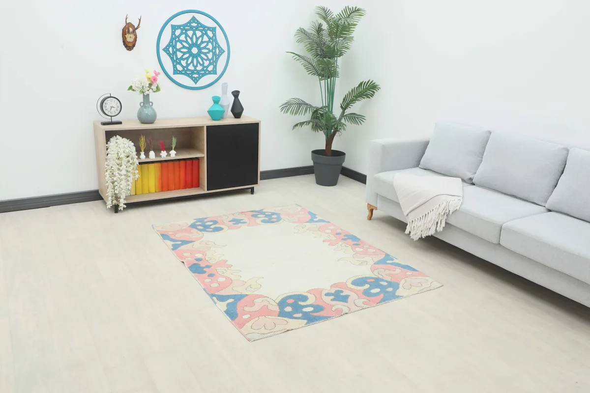 Small area rug displayed in a bright living room setting with a sofa and cabinet.