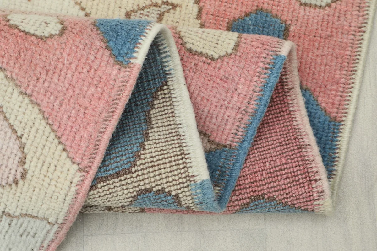 Close-up of the rug's low pile and the texture of the hand-knotted wool.
