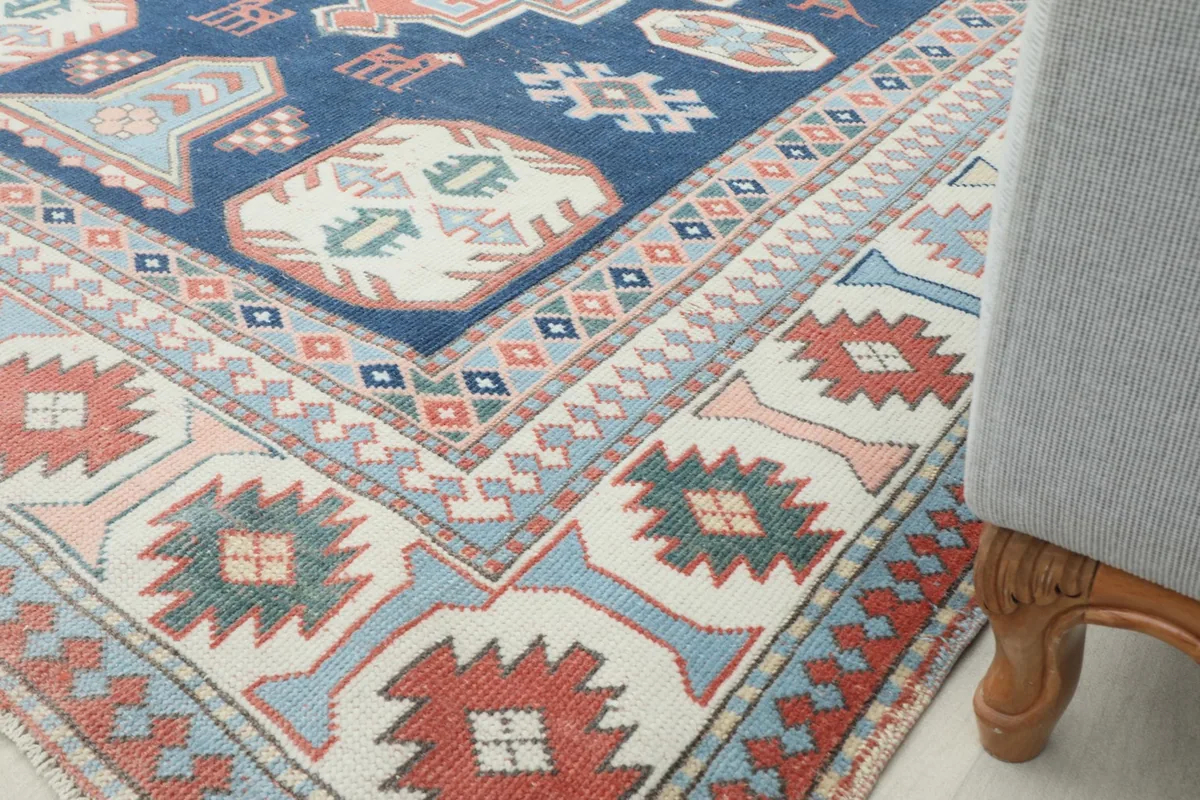 Rug corner under a chair, highlighting its placement in a room