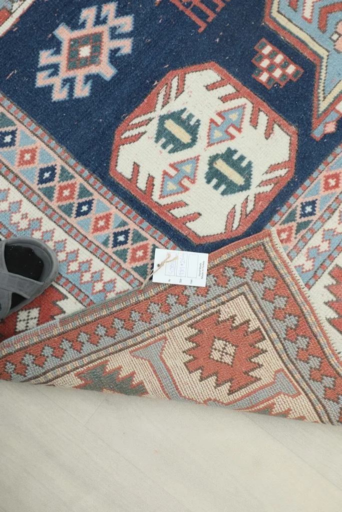 View of the rug's reverse side, showing the hand-knotted cotton foundation