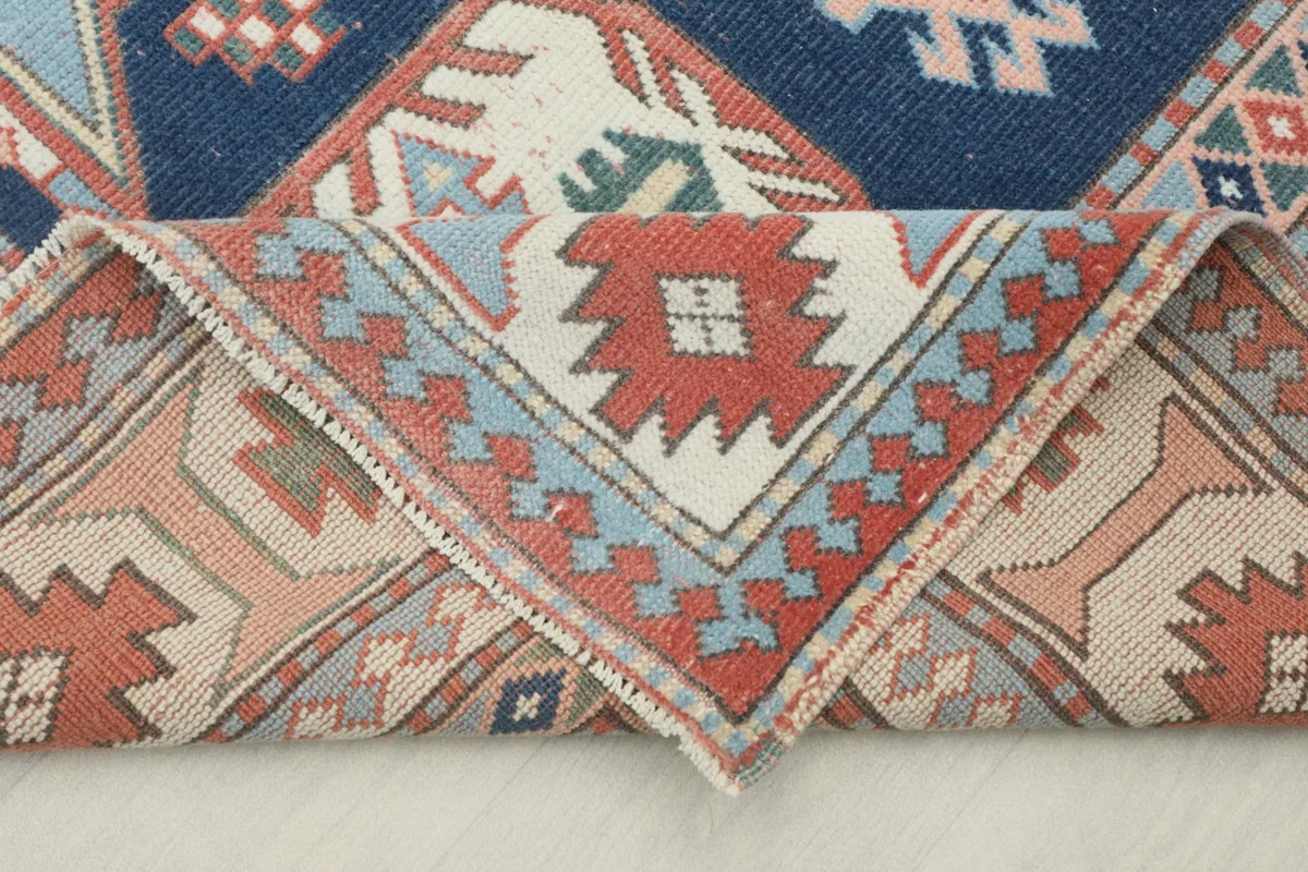 Folded section of the rug revealing the back and pile texture