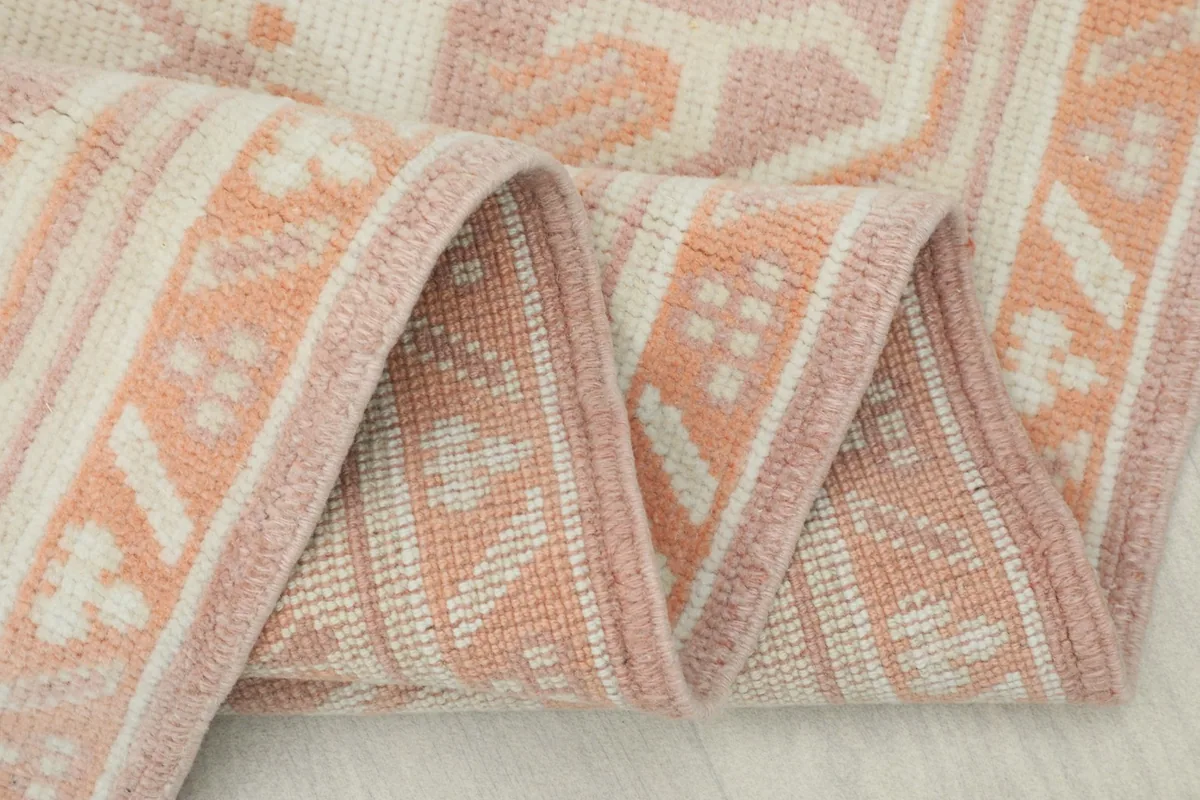 Close-up of the low wool pile texture and tight knotting of the vintage Anatolian rug.