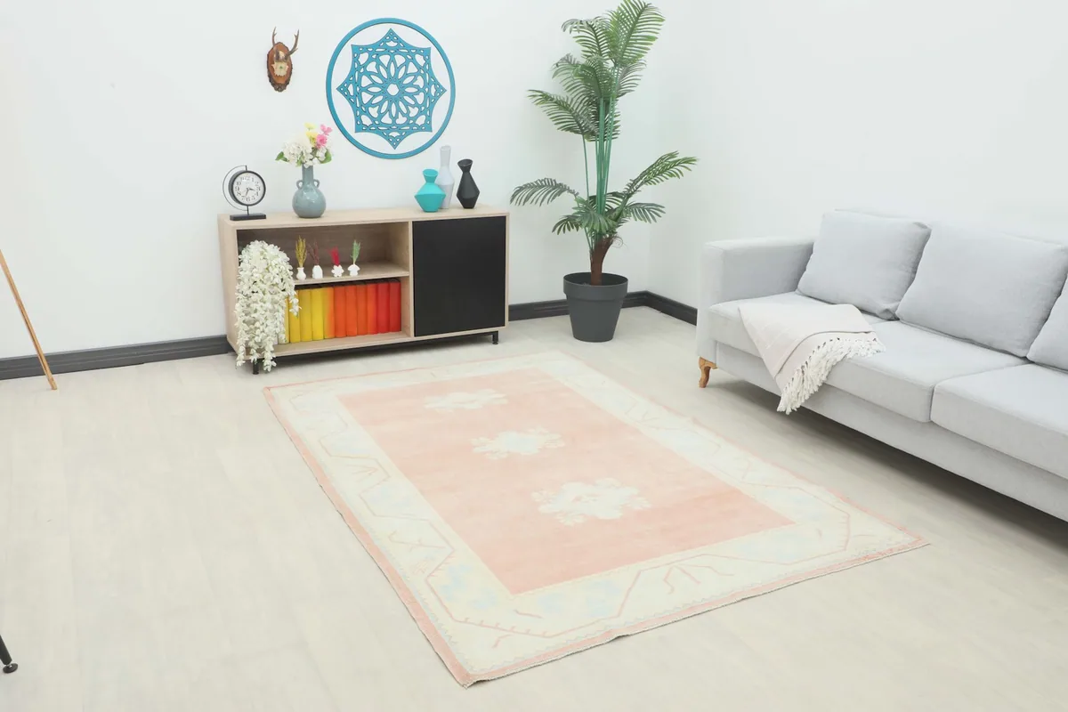 Area rug in a modern room setting, showcasing its size and colors next to a sofa and cabinet