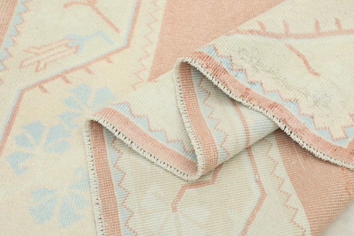 Close-up of the low wool pile texture and the tightly woven structure of the rug