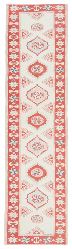 Full top view of an ivory and red geometric Anatolian runner rug