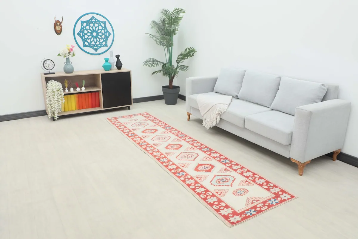 Ivory and red runner rug in a modern living space with a grey sofa