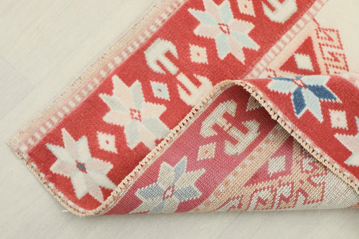 Corner of the rug folded to show the backing and pile texture