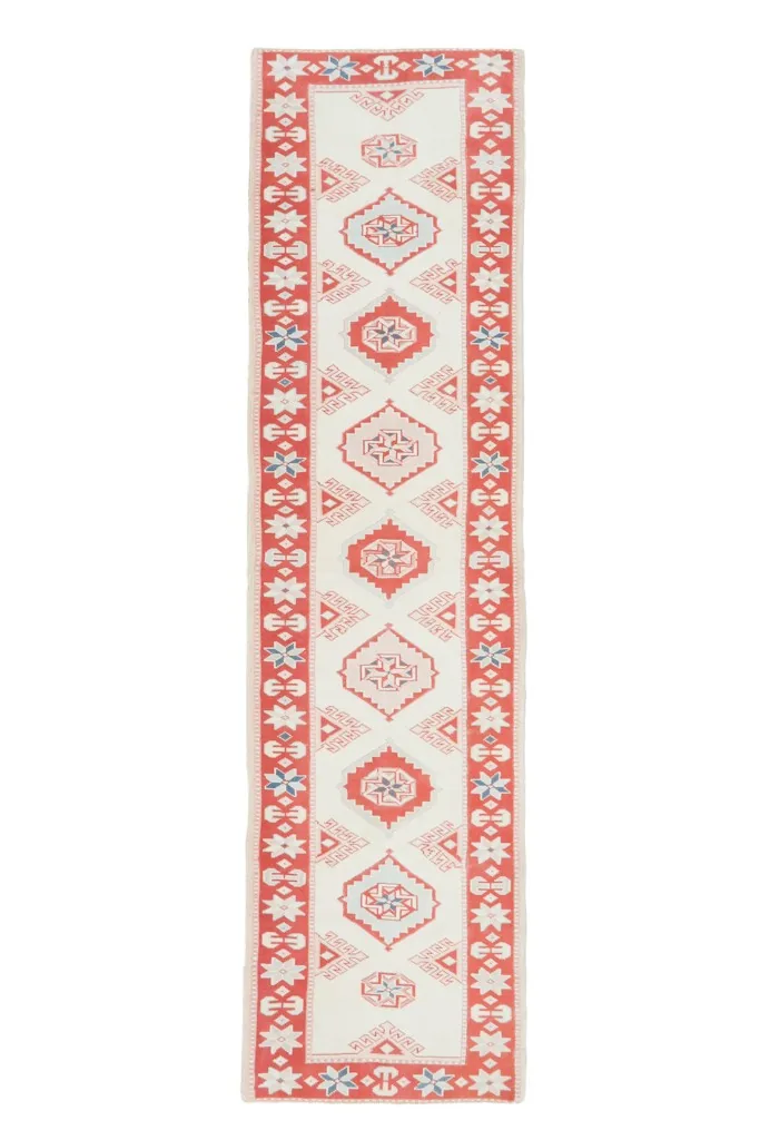 Full overhead view of the ivory and red runner rug on a white background