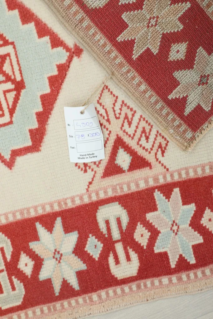 Detail of the rug with a product tag, showing the weave and colors