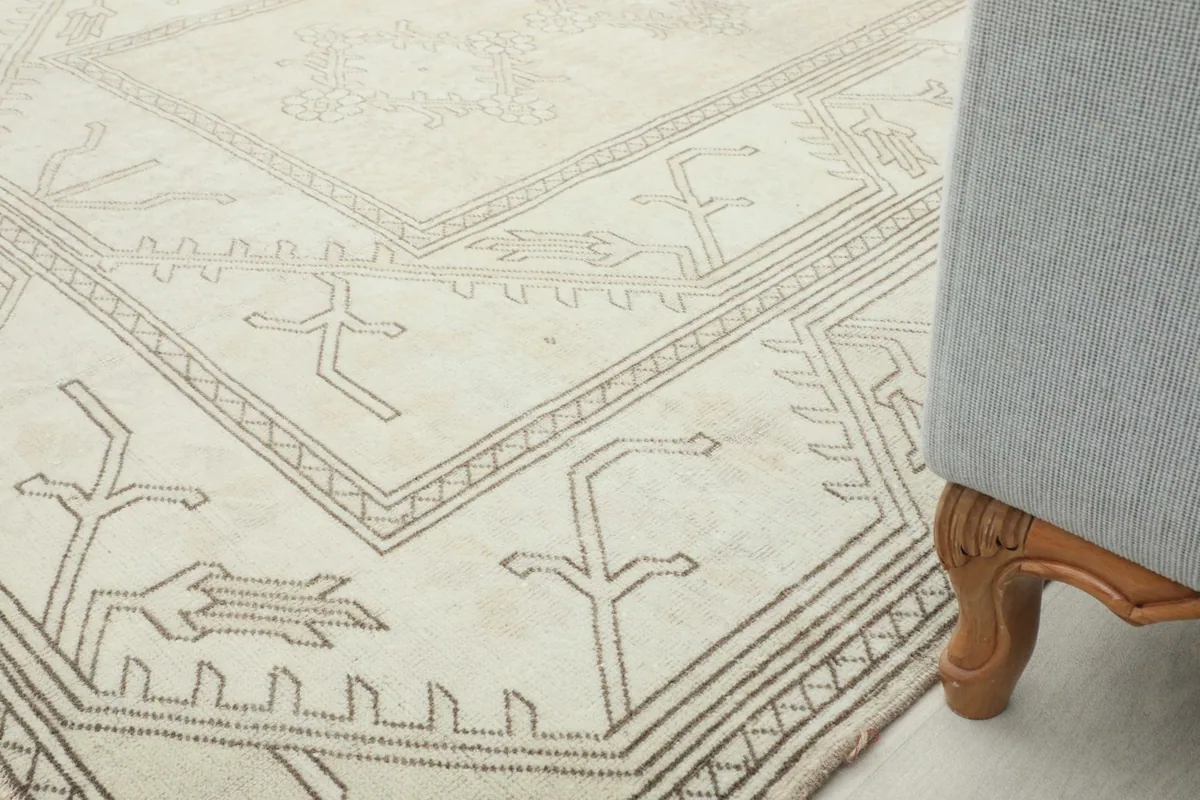Rug corner next to a wooden furniture leg, showing the rug's placement in a room