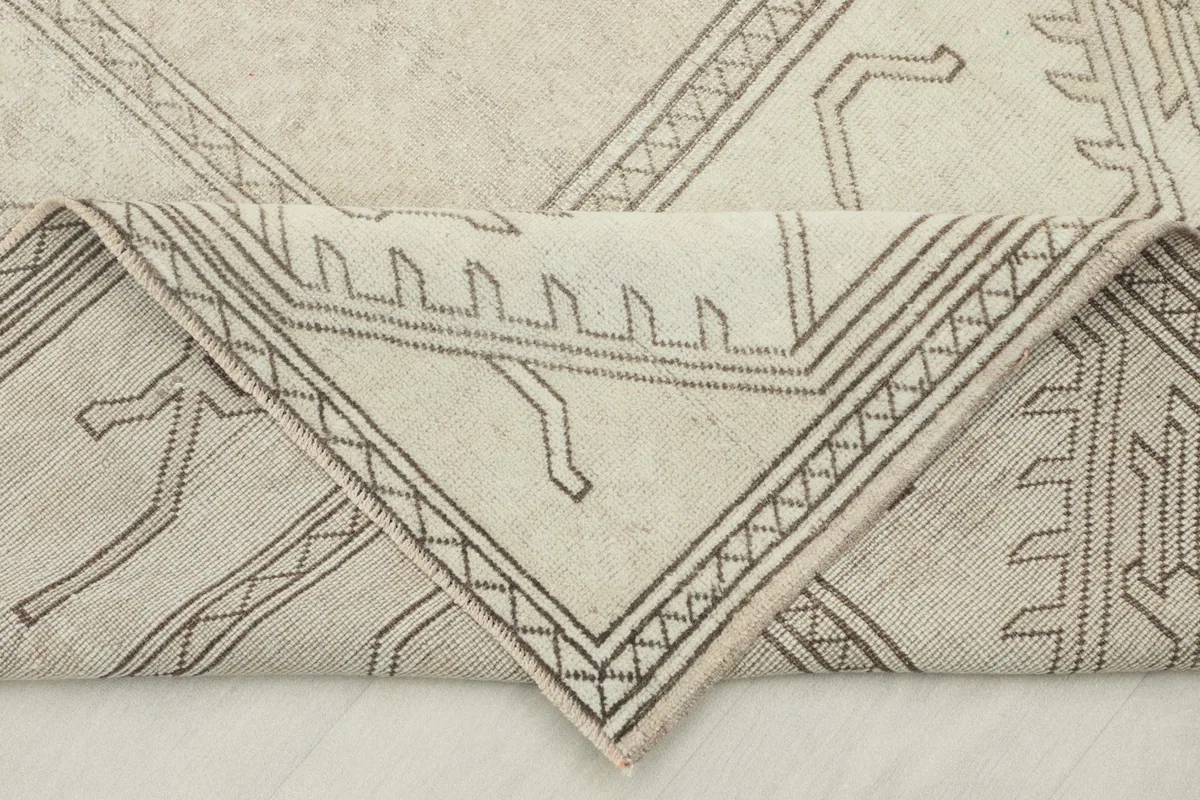 Corner of the hand-knotted rug folded to show the back and weave structure