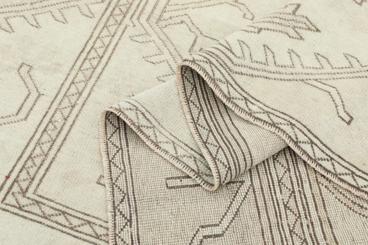 Rolled section of the rug revealing the thickness and cotton foundation