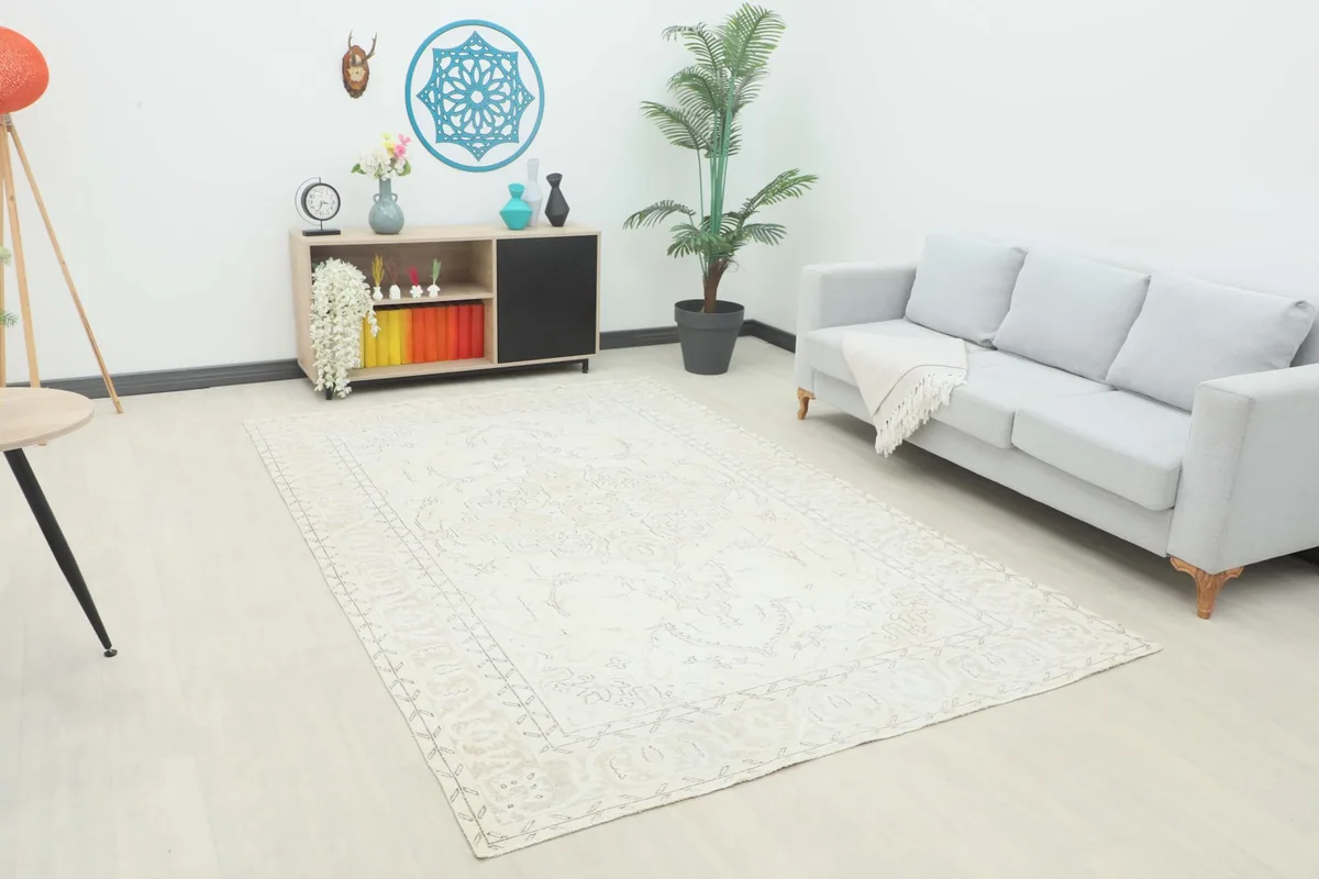 Vintage ivory and gray rug in a living room setting with a light gray sofa