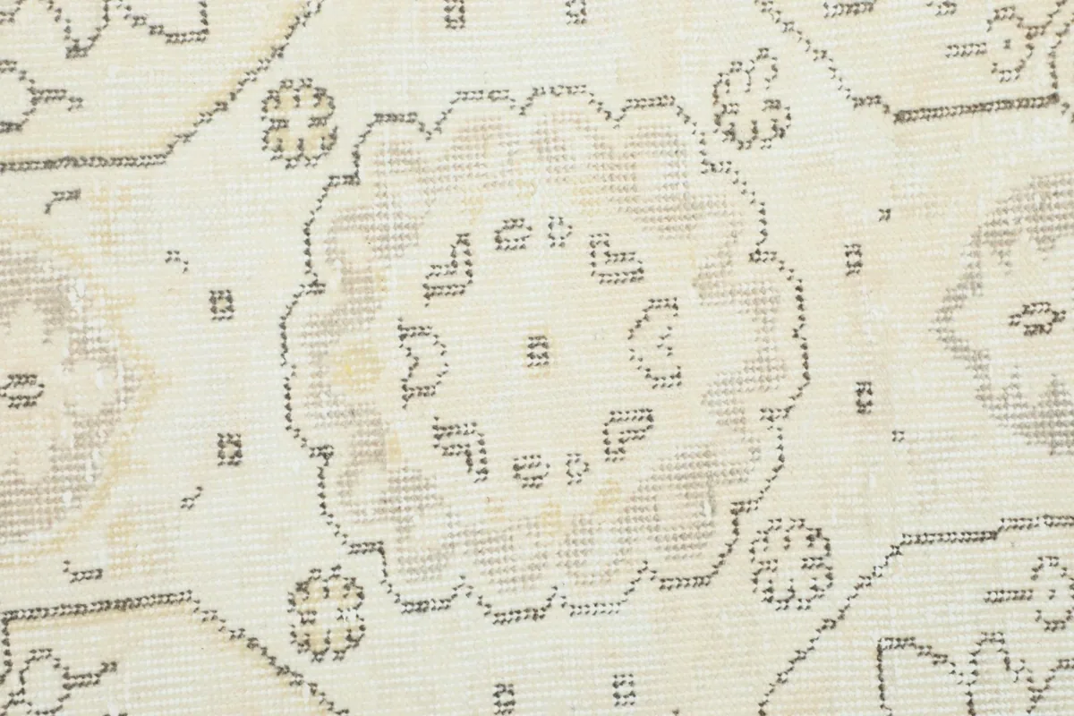 Close-up of a small floral medallion motif within the rug's pattern