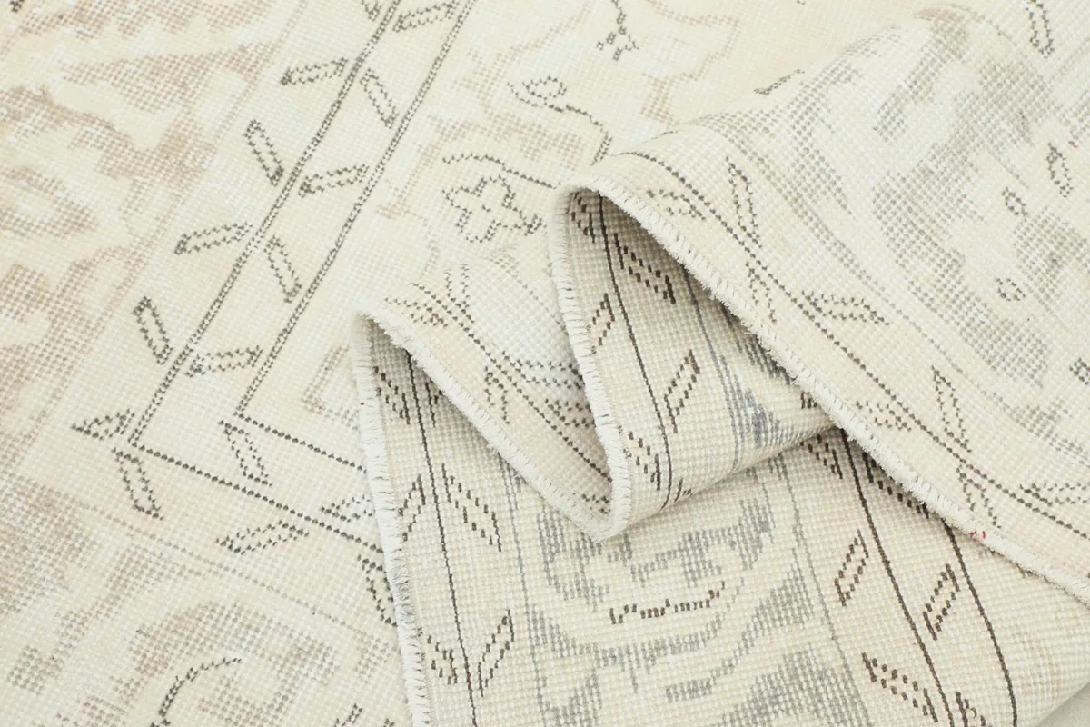Folded section of the rug, highlighting the soft texture and subtle color variations