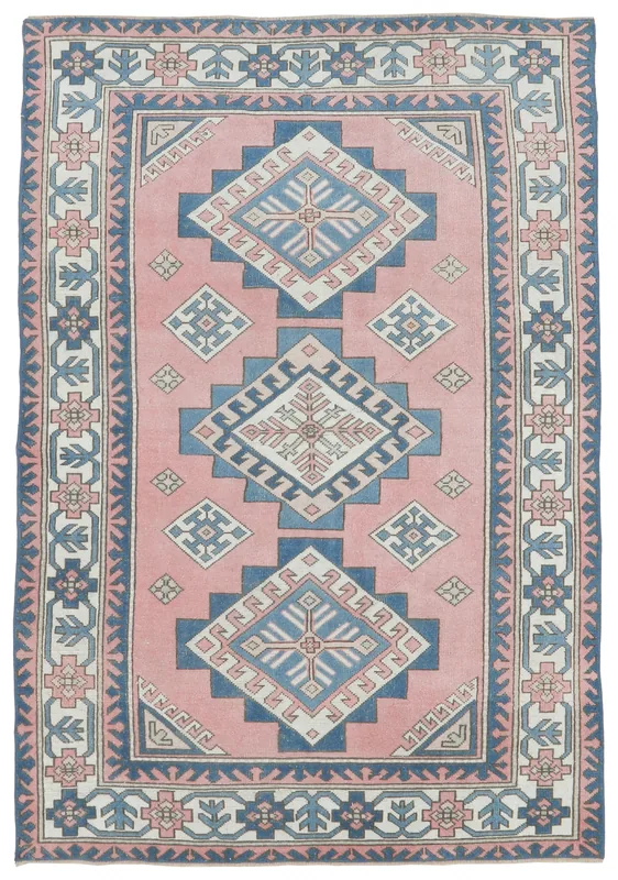 Full overhead view of the vintage Anatolian rug with rose field and blue geometric patterns