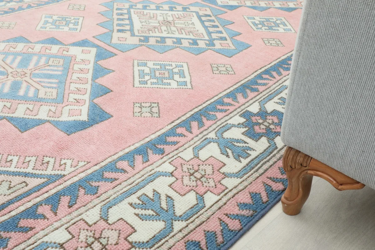 Rug placed under a sofa, showing how it anchors the living room seating area
