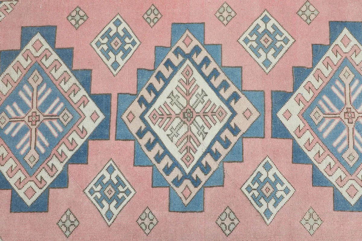 Detailed view of the central rose field with large blue and ivory diamond motifs