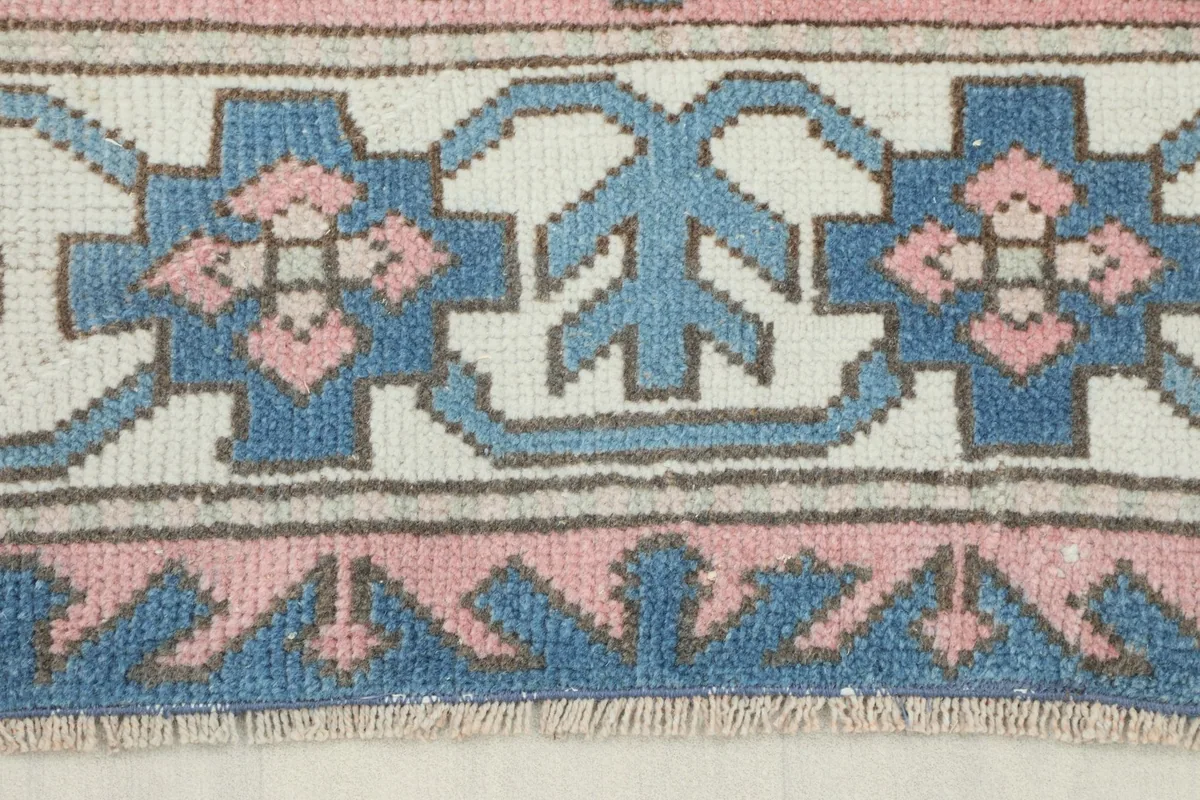 Close-up of the blue and ivory border design with intricate geometric motifs