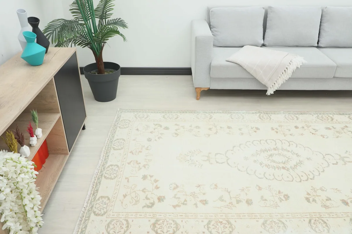 Angle view of the rug in a living room setting, showcasing its placement beneath a sofa.