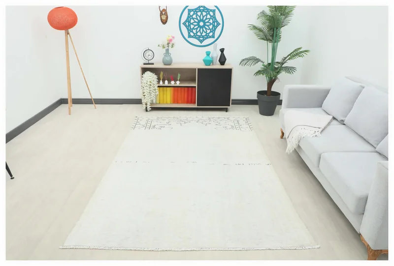 Full top view of the 5'6" x 8'9" ivory vintage Anatolian area rug on a white background.
