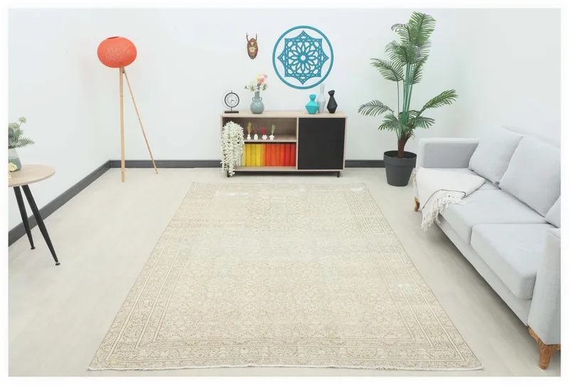 Full top view of the 6'3" x 9'4" beige floral vintage Anatolian rug on a white background