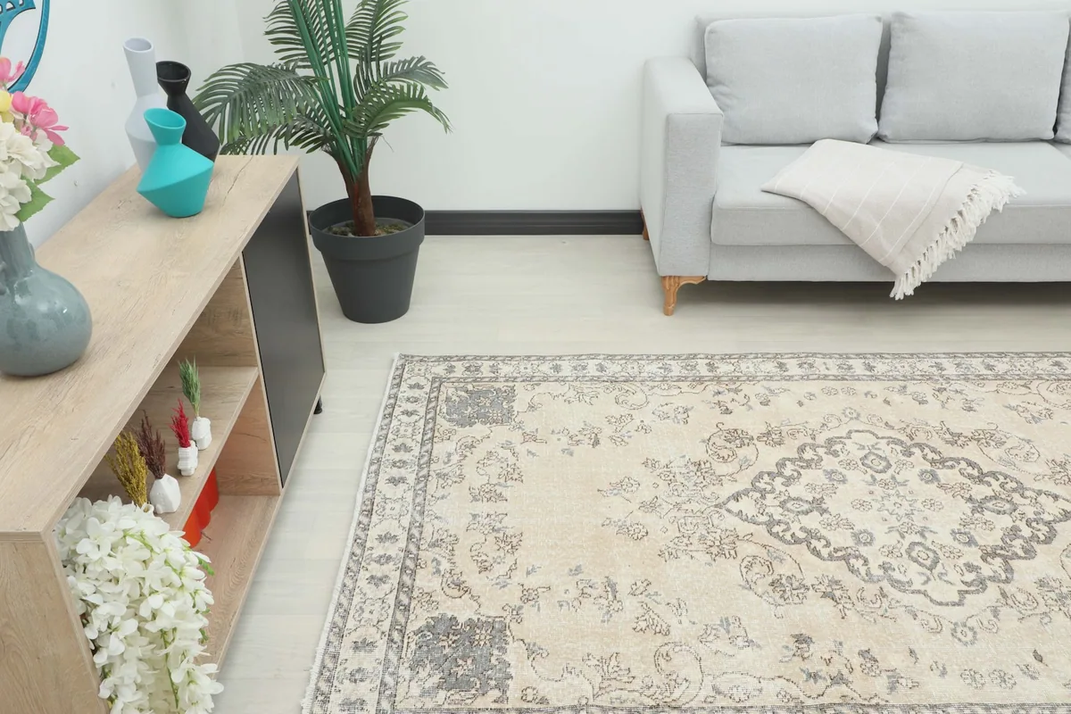 Angle view of the rug in a room, showing its placement relative to a sofa and cabinet.