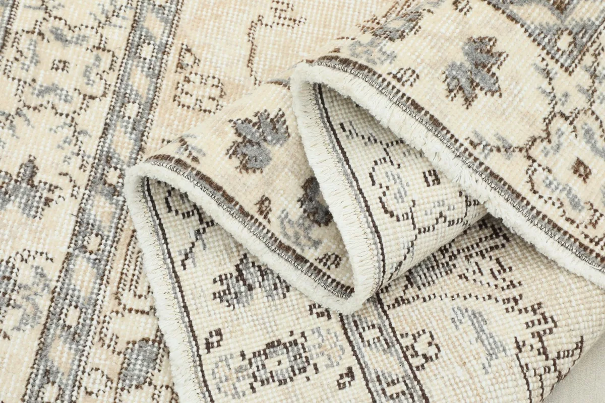 Another folded view of the rug, emphasizing the texture and the consistency of the knotting.
