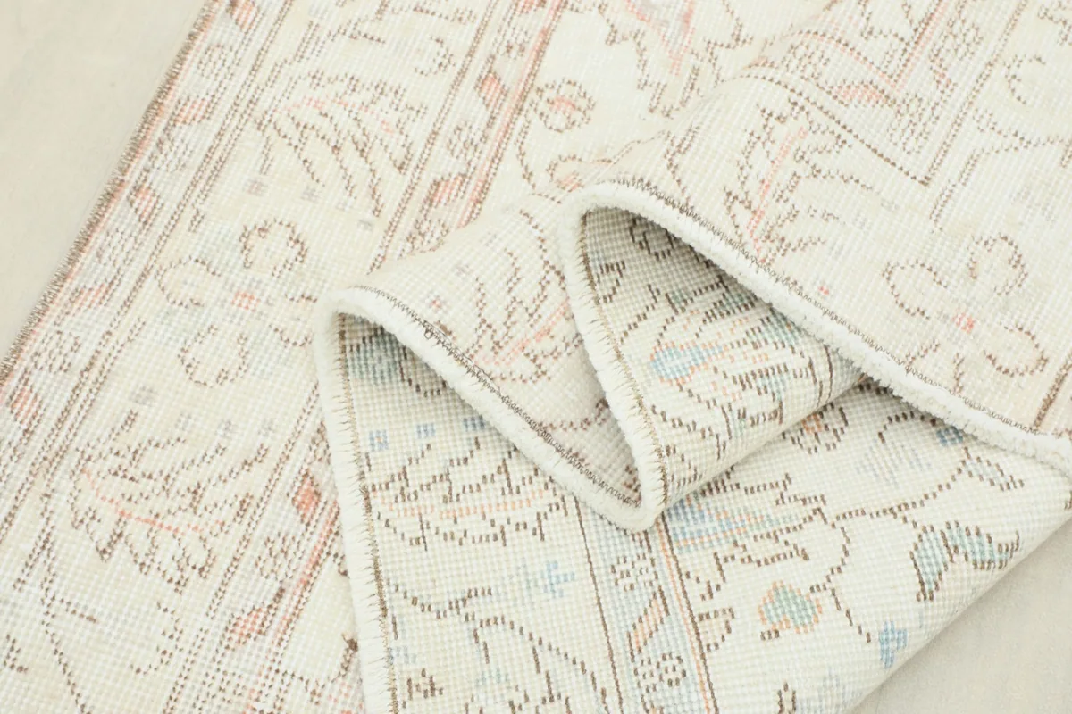 Rug folded to show the flexibility and texture of the vintage wool pile and backing.