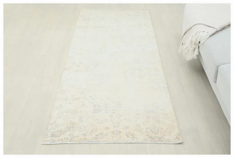 Full top view of the cream and blue vintage Anatolian runner rug on a white background.