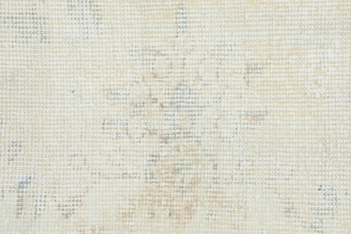 Macro view of the rug's low pile, showing the hand-knotted wool texture and subtle color variations.