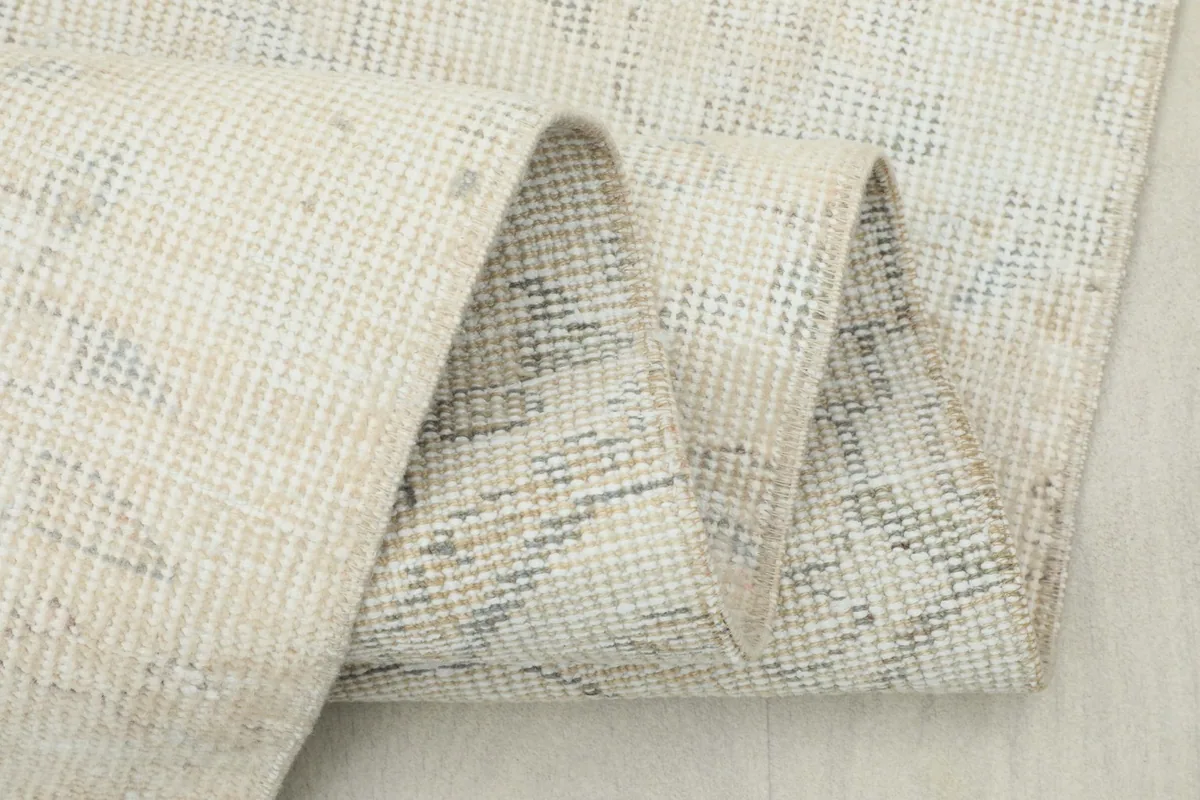 Close-up of the rug's reverse side, showing the tight hand-knotted weave and cotton foundation.