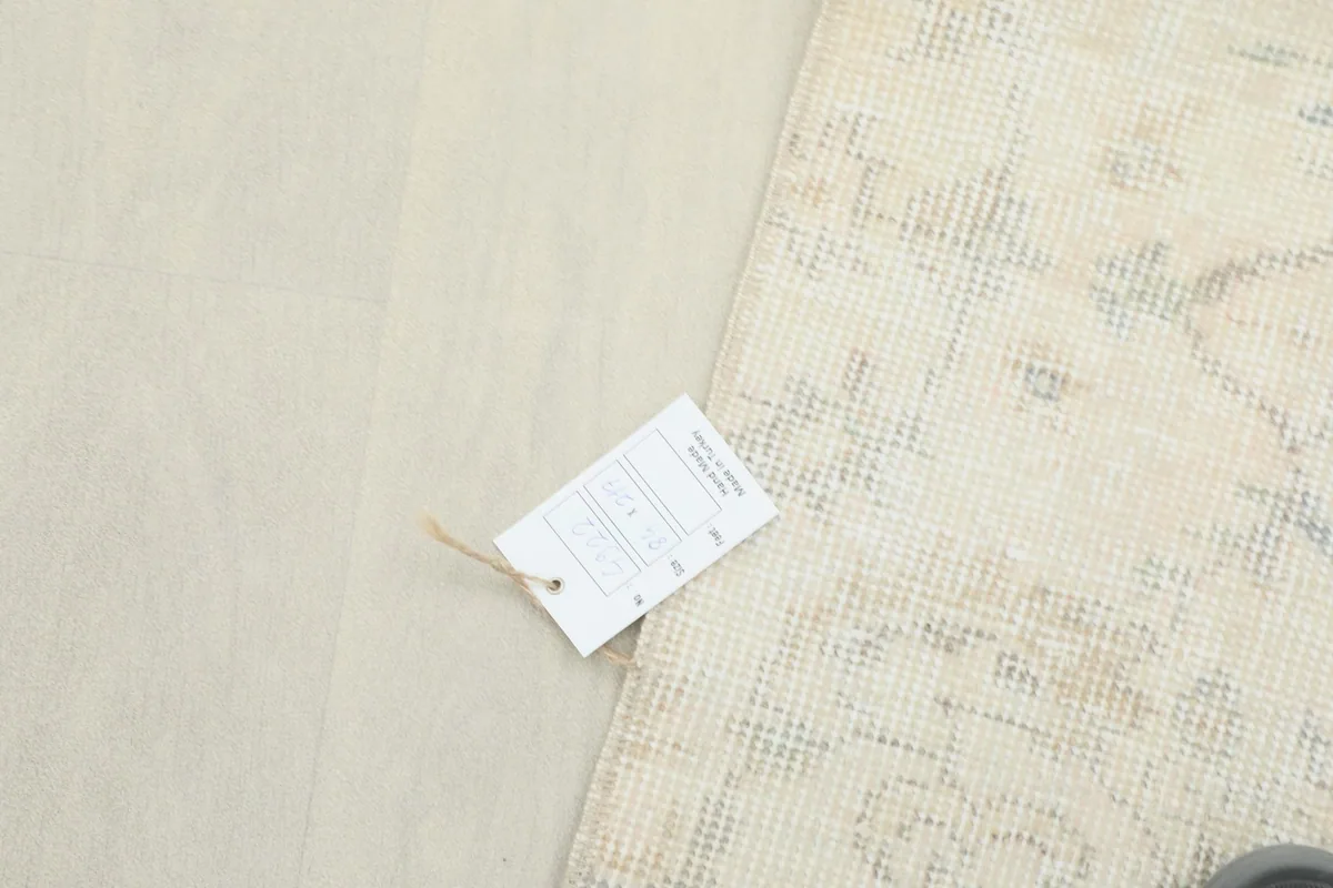 Rug tag resting on the corner of the rug, displaying product information.