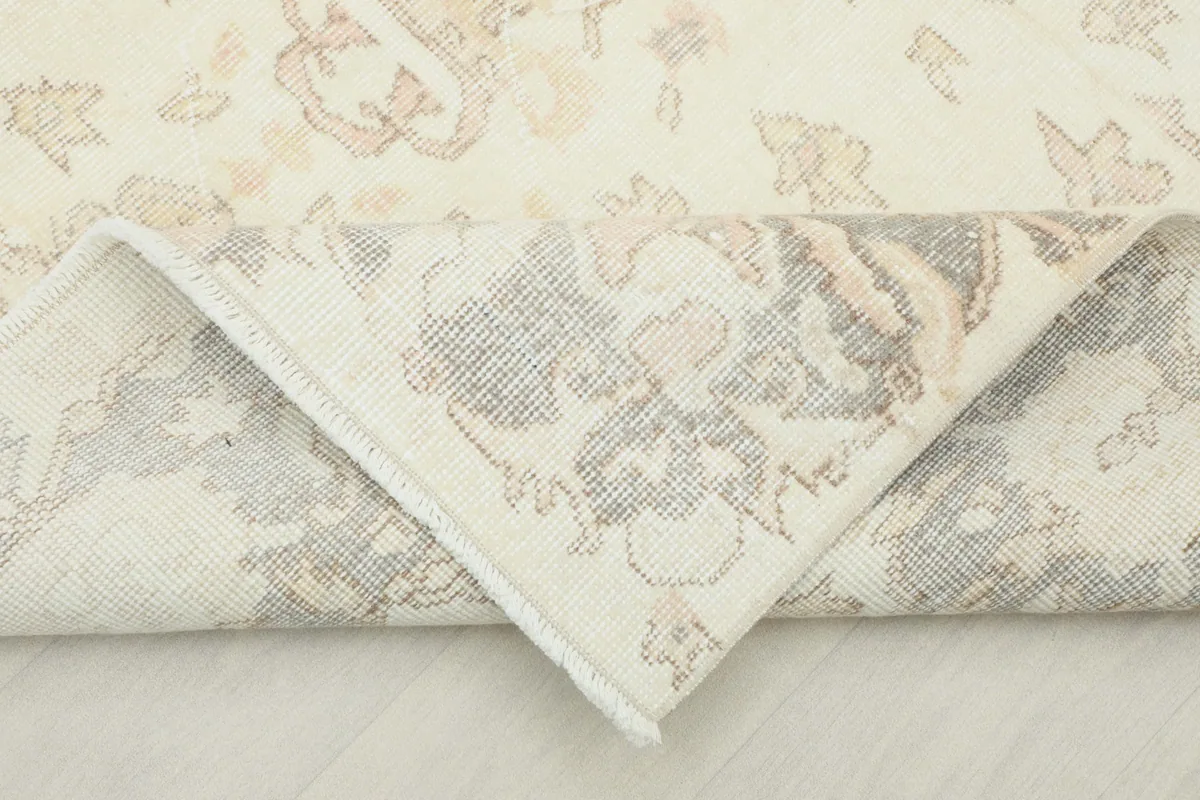 Folded corner revealing the cotton foundation and hand-knotted construction