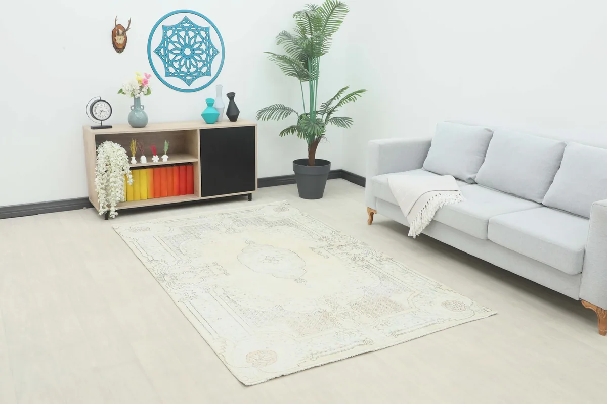 Vintage ivory and beige rug placed in a modern living room setting