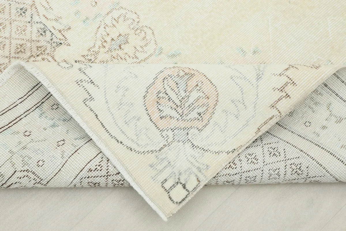 Folded corner showing the back of the hand-knotted wool pile rug