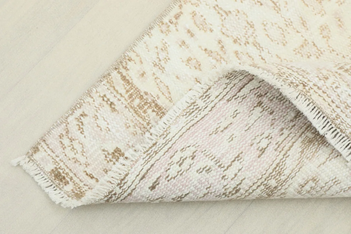 View of the back of the hand-knotted rug, revealing the cotton foundation and construction.