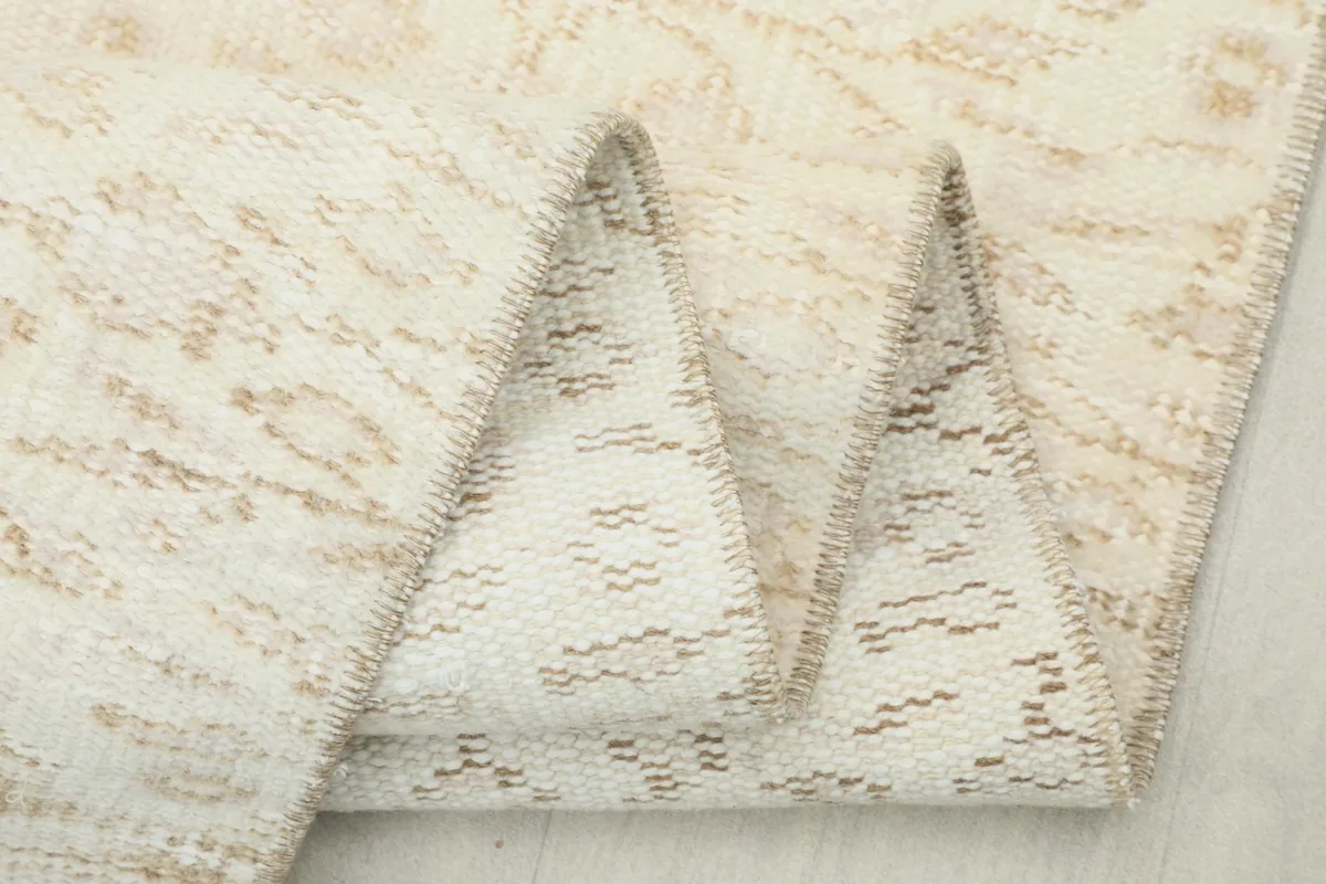 Close-up of the rug folded, highlighting the texture and weave from different angles.