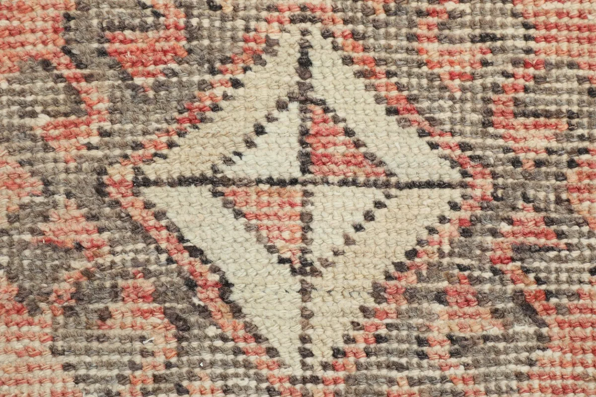 Extreme close-up of the hand-knotted wool pile, showing individual knots and color variations.